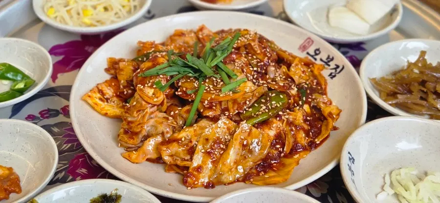 Side dishes including sausage vegetable stir-fry and white kimchi