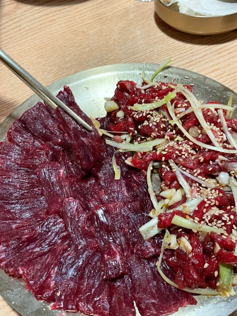 Picking up a piece of raw beef