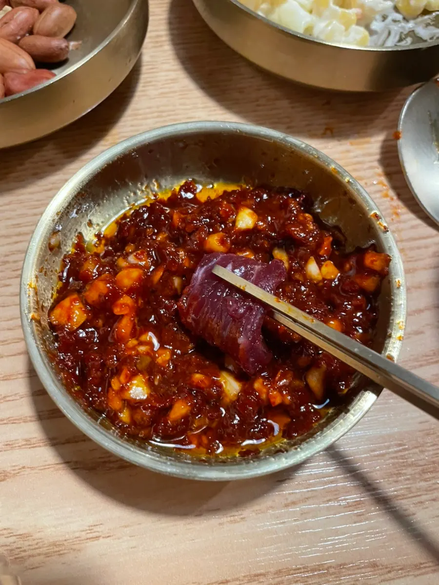 Raw beef dipped in soy-based sauce