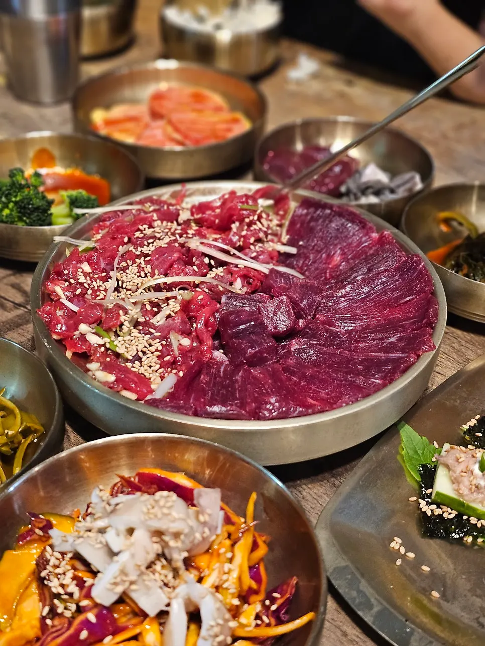 Raw beef side dish paired with a glass of beer