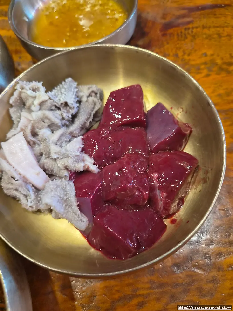 Plate of raw liver, tripe, and sesame oil dip