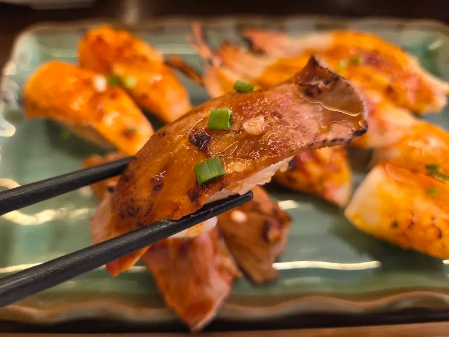 Small plate of spicy sauce flame-seared sushi