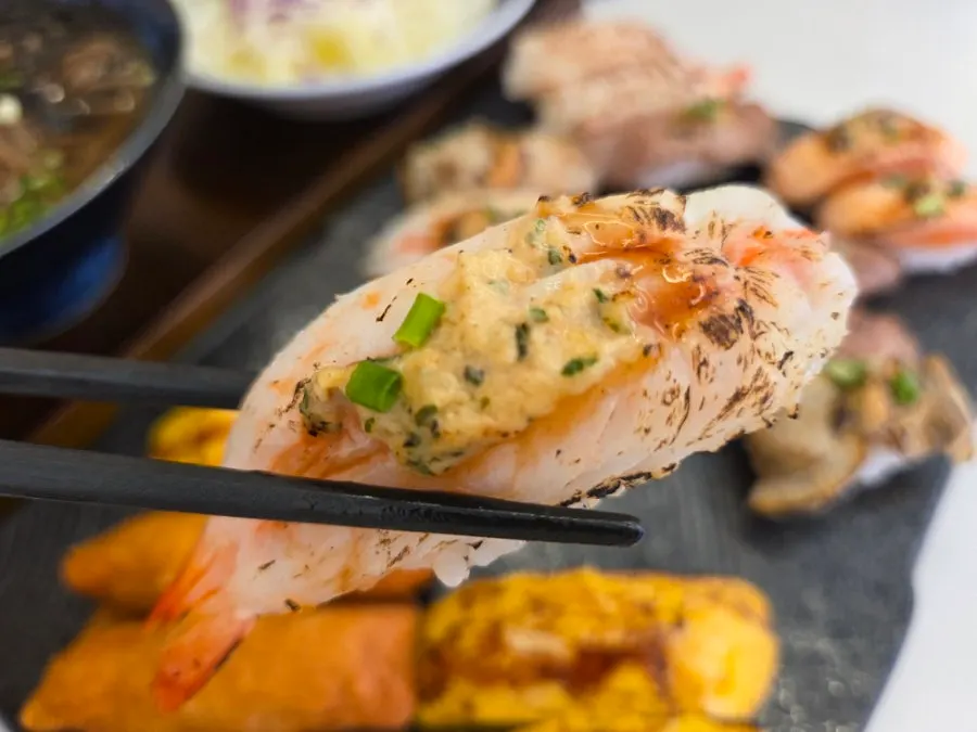 Close-up of garlic sauce flame-seared sushi