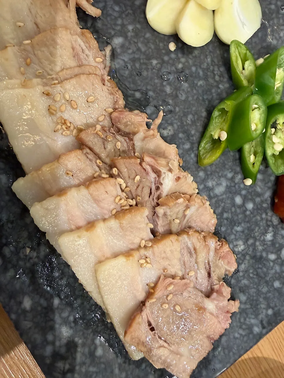 Bossam meat served with white kimchi