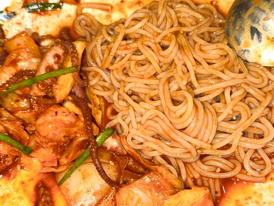 Close-up of octopus stir-fry cut with scissors