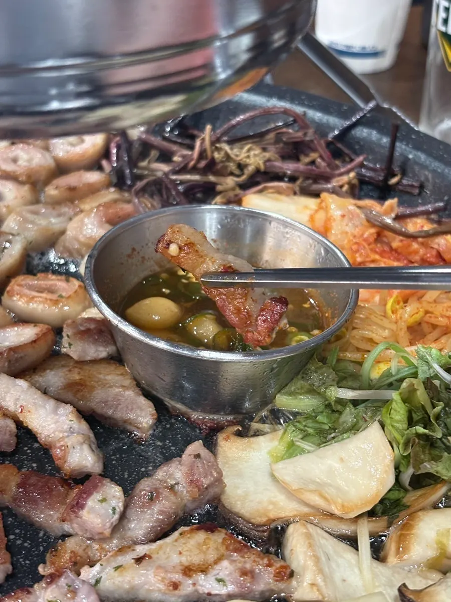 A piece of raw pork belly dipped in galchi sokjeot