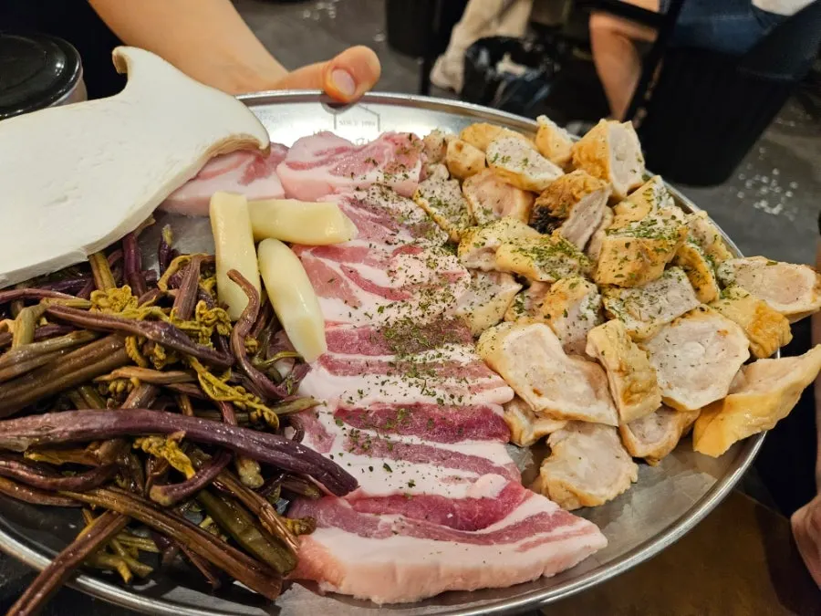 Table set with a makchang platter and half samgyeopsal platter