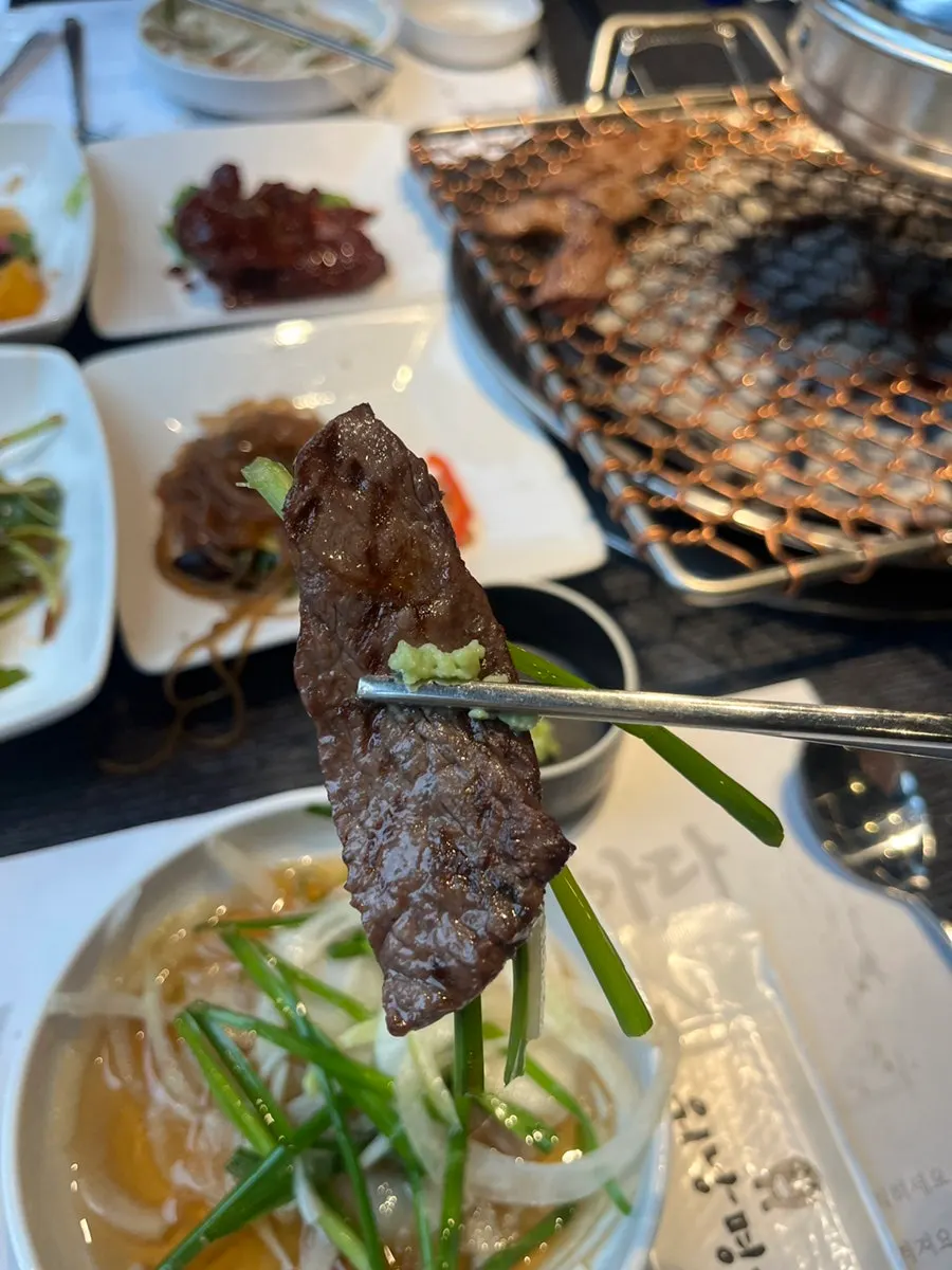 Thick hanwoo cooking over charcoal