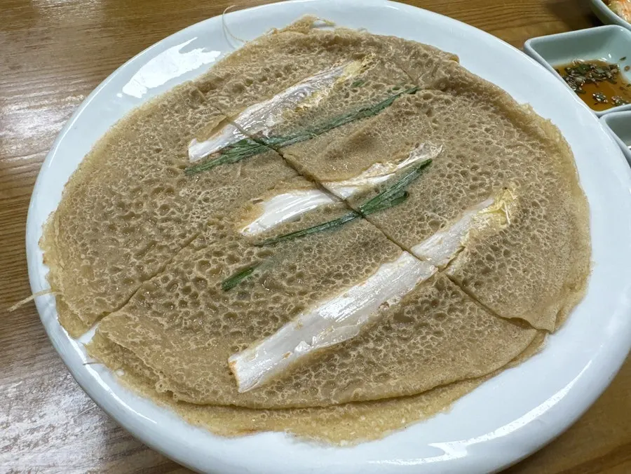 Thin buckwheat pancake topped with napa cabbage