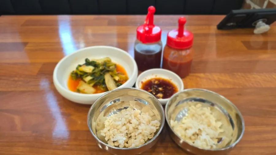 Basic table setting of barley rice, kimchi, perilla oil, and gochujang