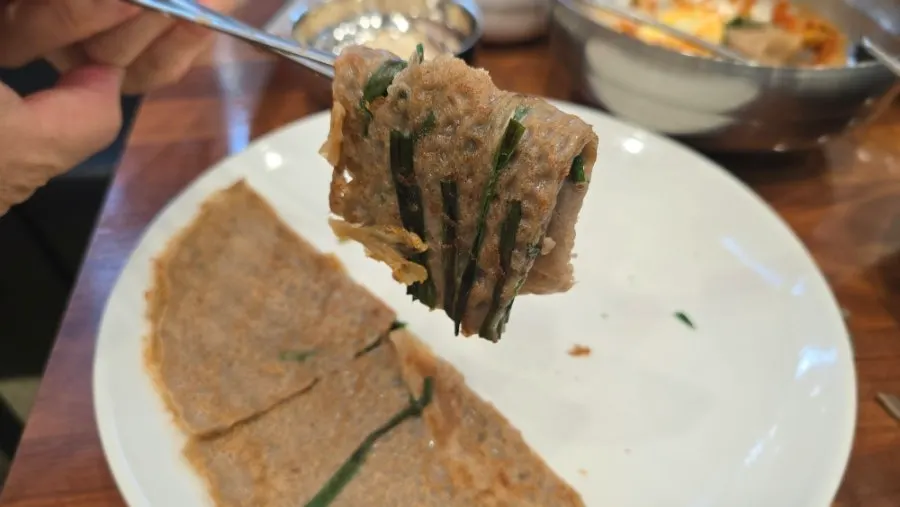 Buckwheat pancake dipped in soy sauce