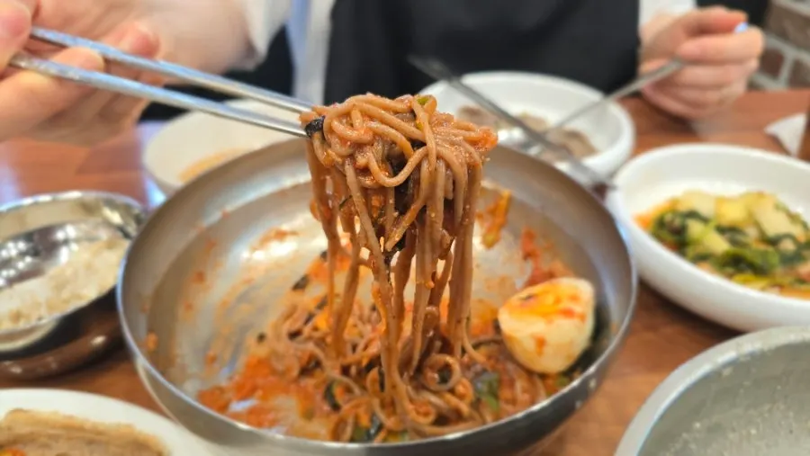 Bibim makguksu mixed with a sweet-and-tangy sauce