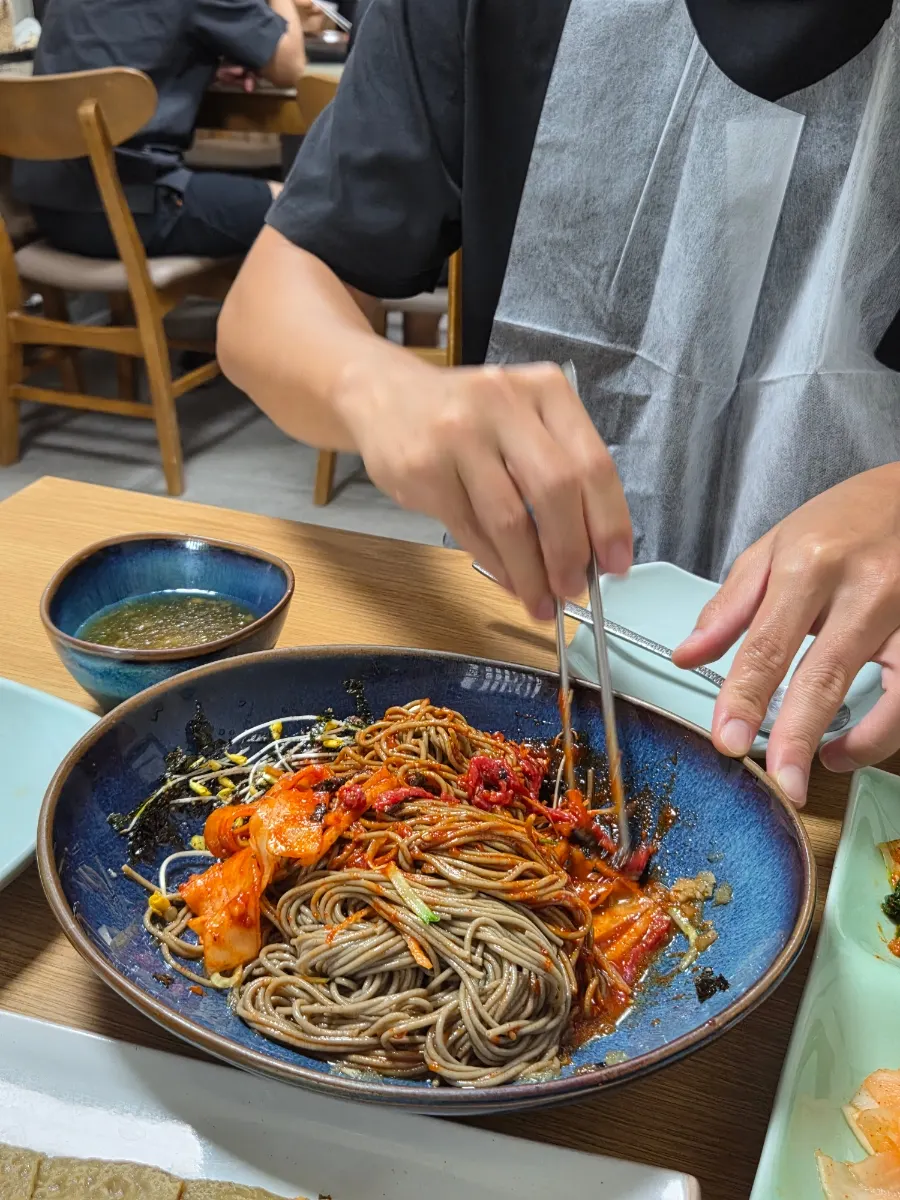Buckwheat noodles and yukhoe wrapped in kimchi