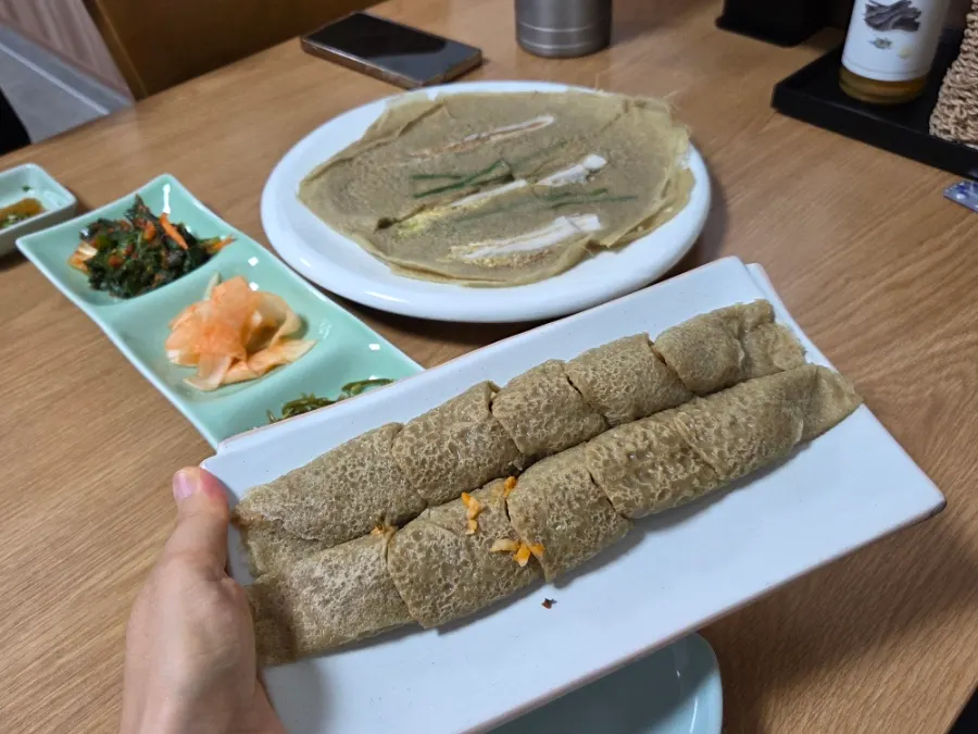 Cross-section of memil-jeonbyeong filled with seasoned radish and glass noodles