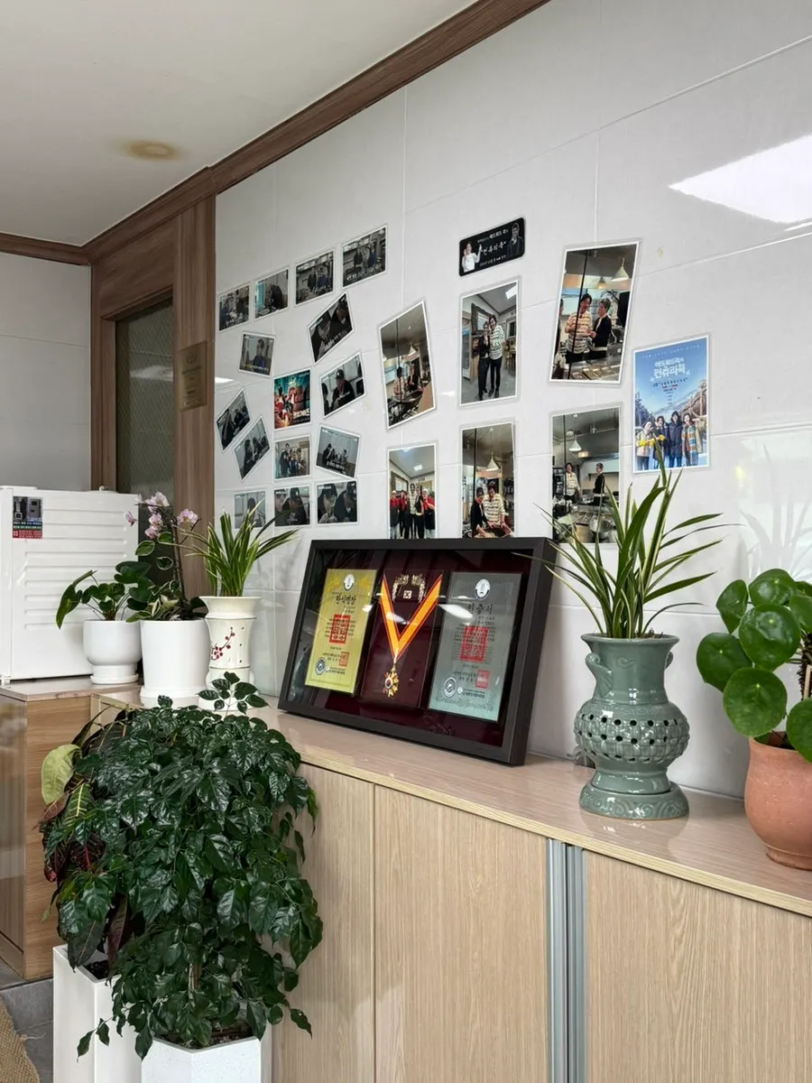 Photos of visiting chefs hung at the entrance