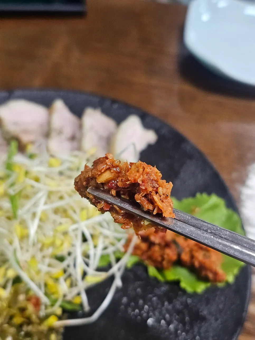 메밀싹 수육 쌈 싸 먹는 모습