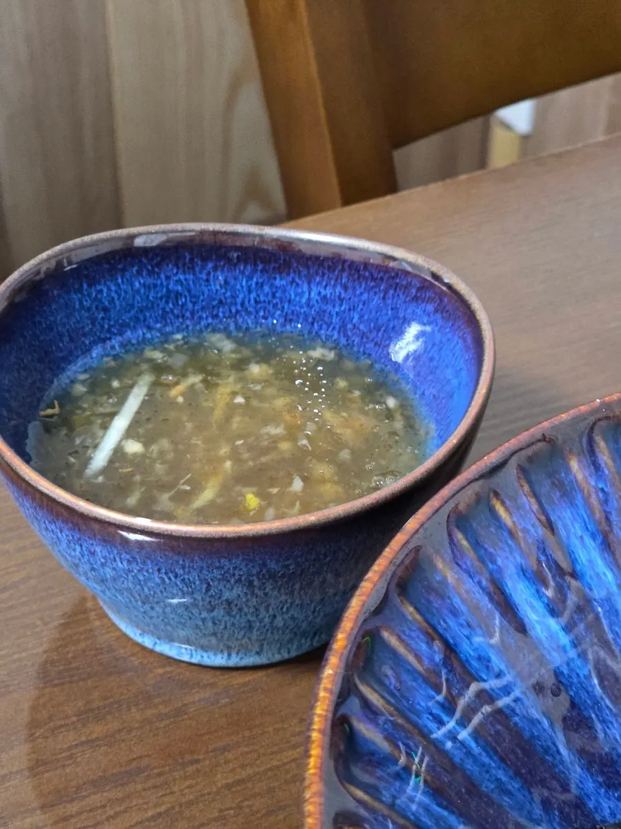 Bowl of broth served alongside the makguksu