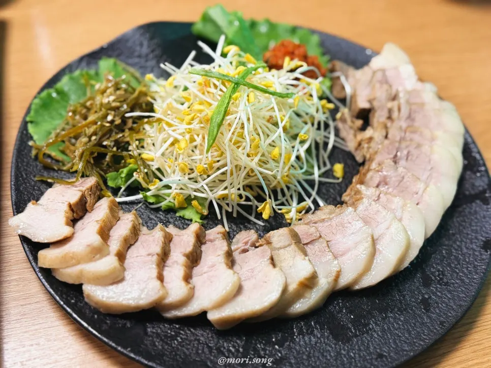 A bite of noodles topped with buckwheat sprouts