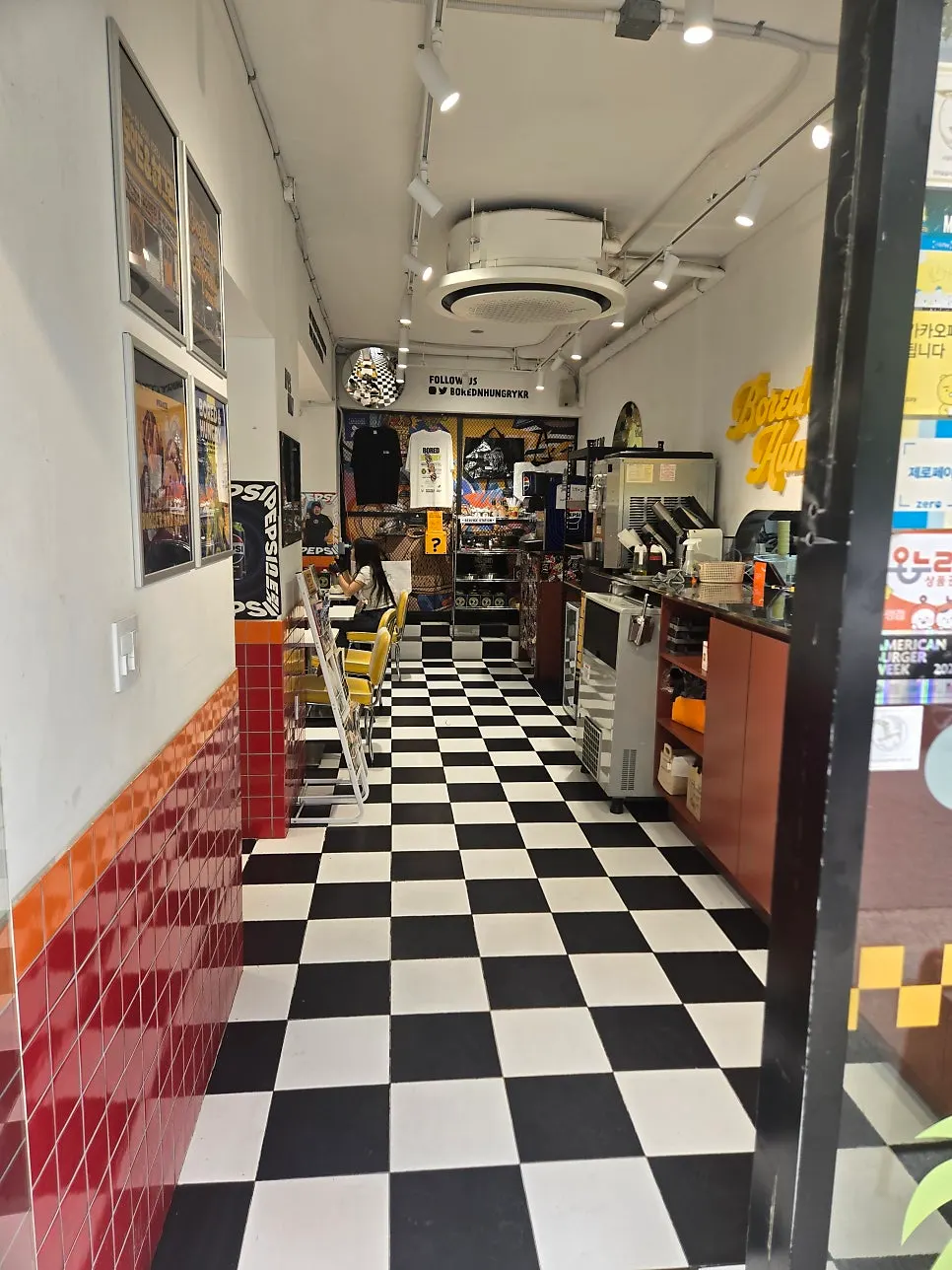 American diner-style interior with red tile walls