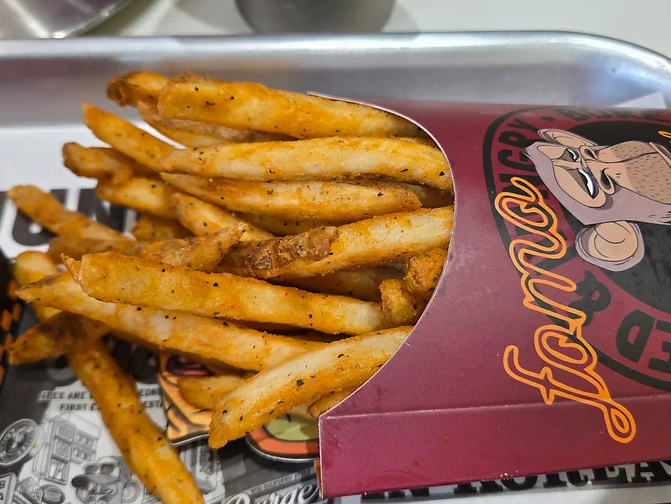 Crinkle-cut butter garlic fries topped with plenty of sauce