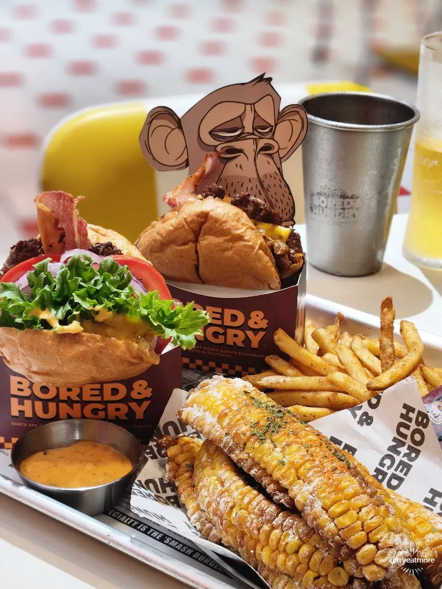 Two smash burgers on a logo-printed tray