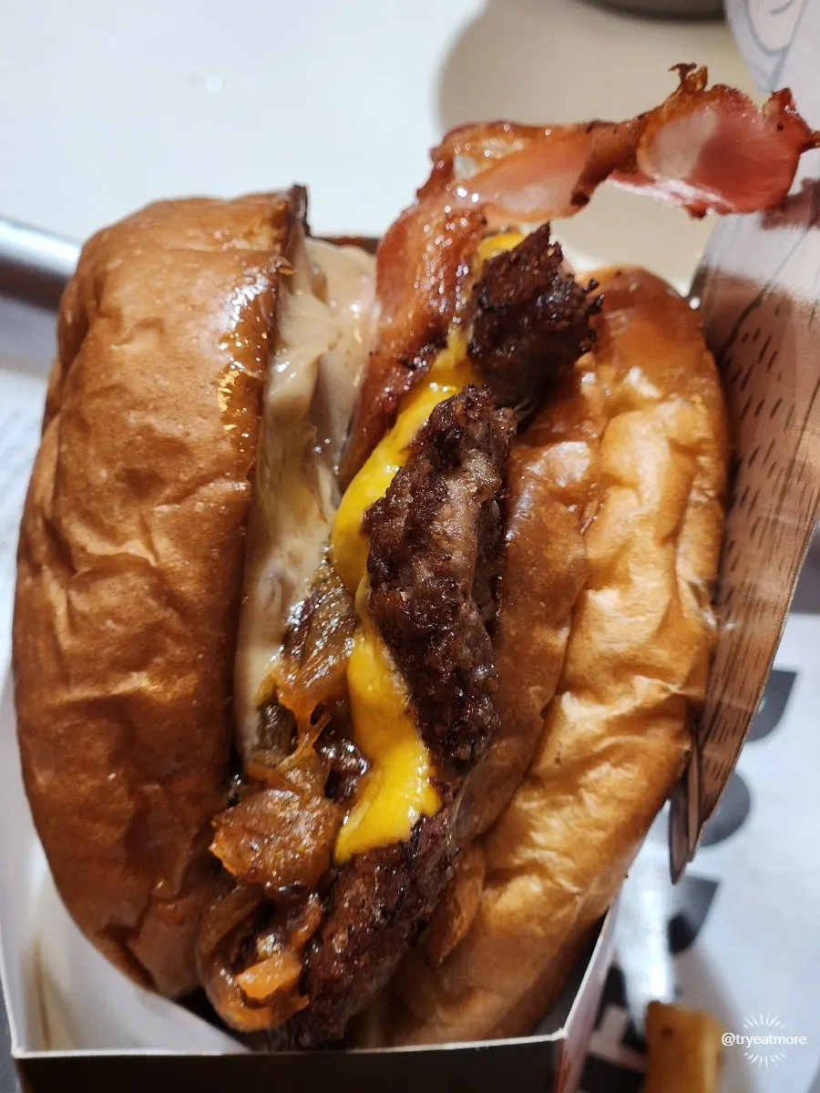 Cross-section of the Bacon Deluxe Burger with thick tomato
