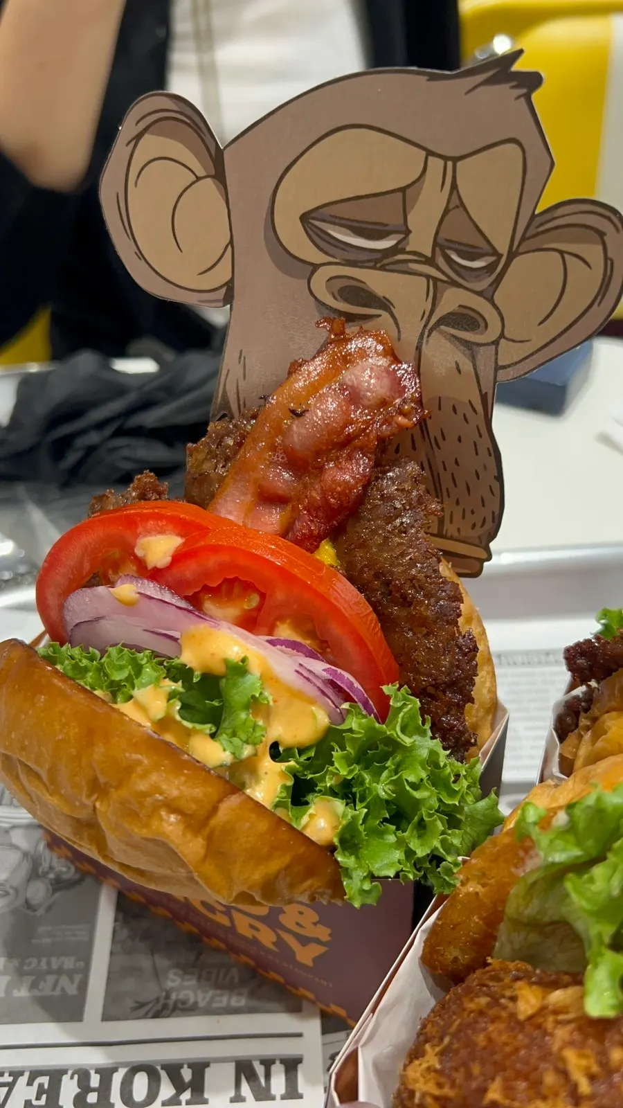 Side view of the burger stacked with patty, cheese, and vegetables