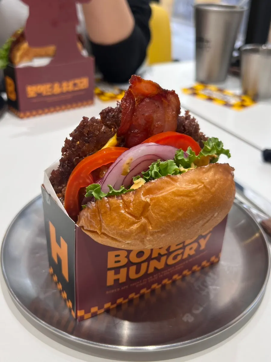 Holding the thick handmade burger