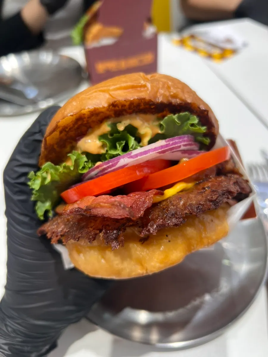 The bacon deluxe burger and drink nearly finished