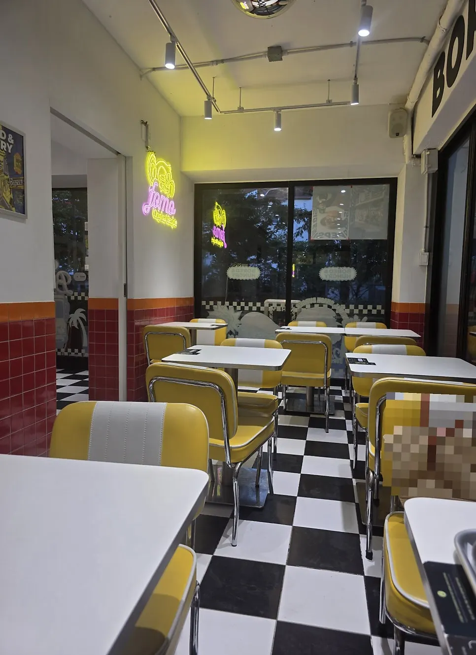 Two-person table seating with neon signs and graffiti