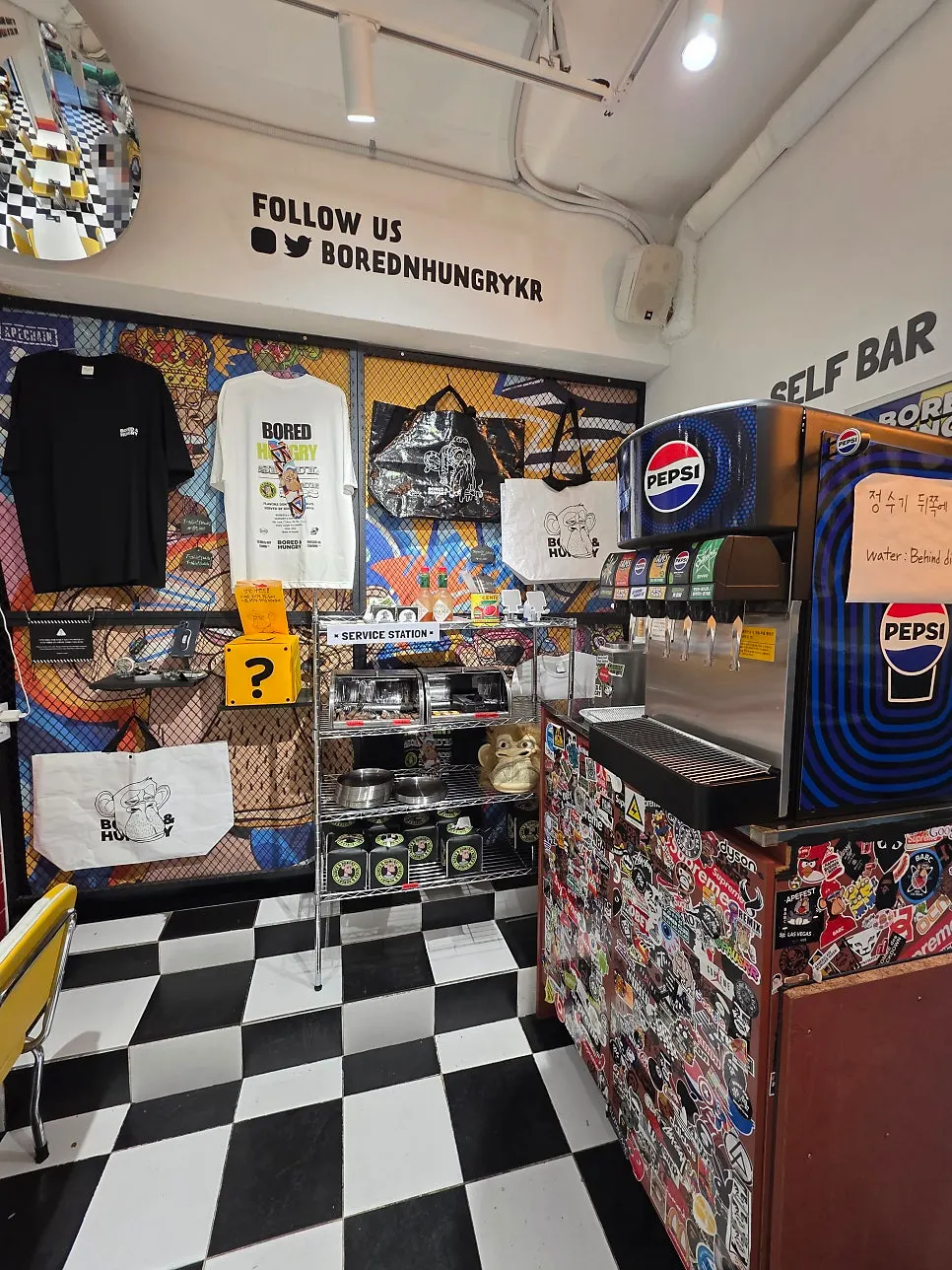 Goods corner with T-shirts and canvas bags