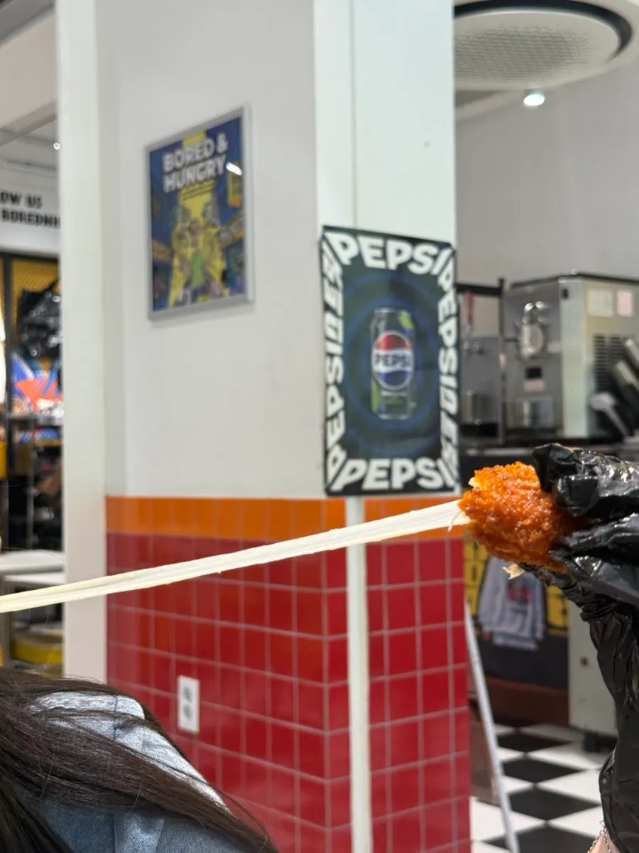 Mozzarella cheese stick stretching apart