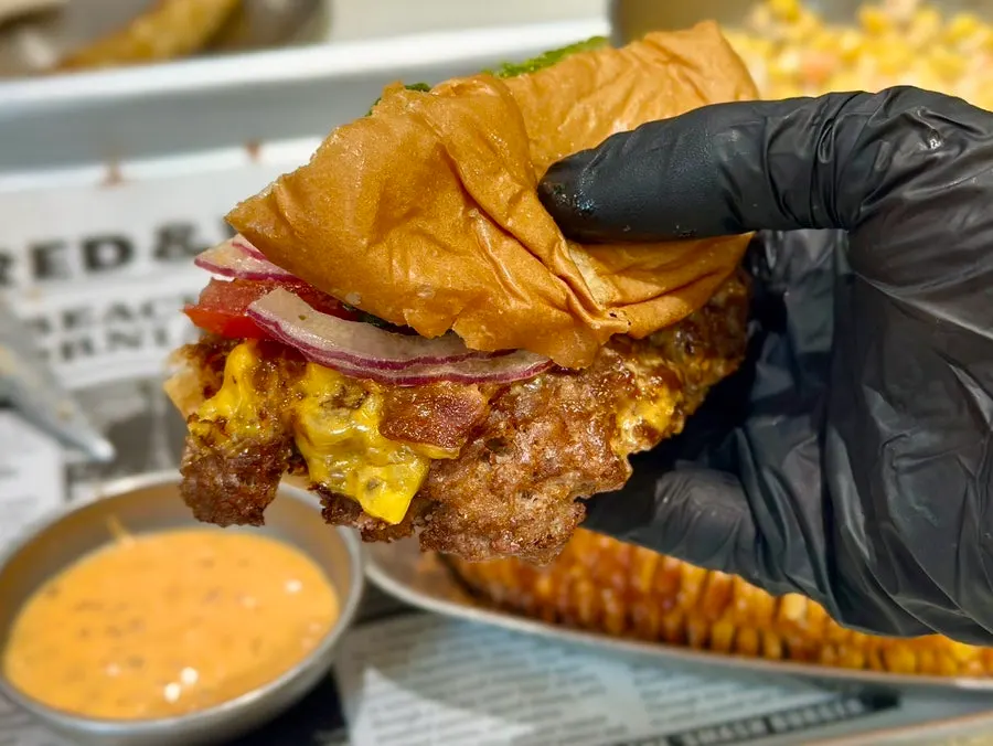 A bite-sized cross-section of the Bacon Deluxe with vegetables