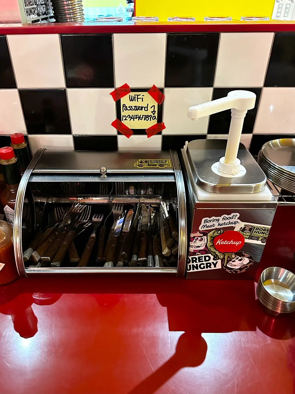 Shelf in the self-serve zone with cutlery and gloves