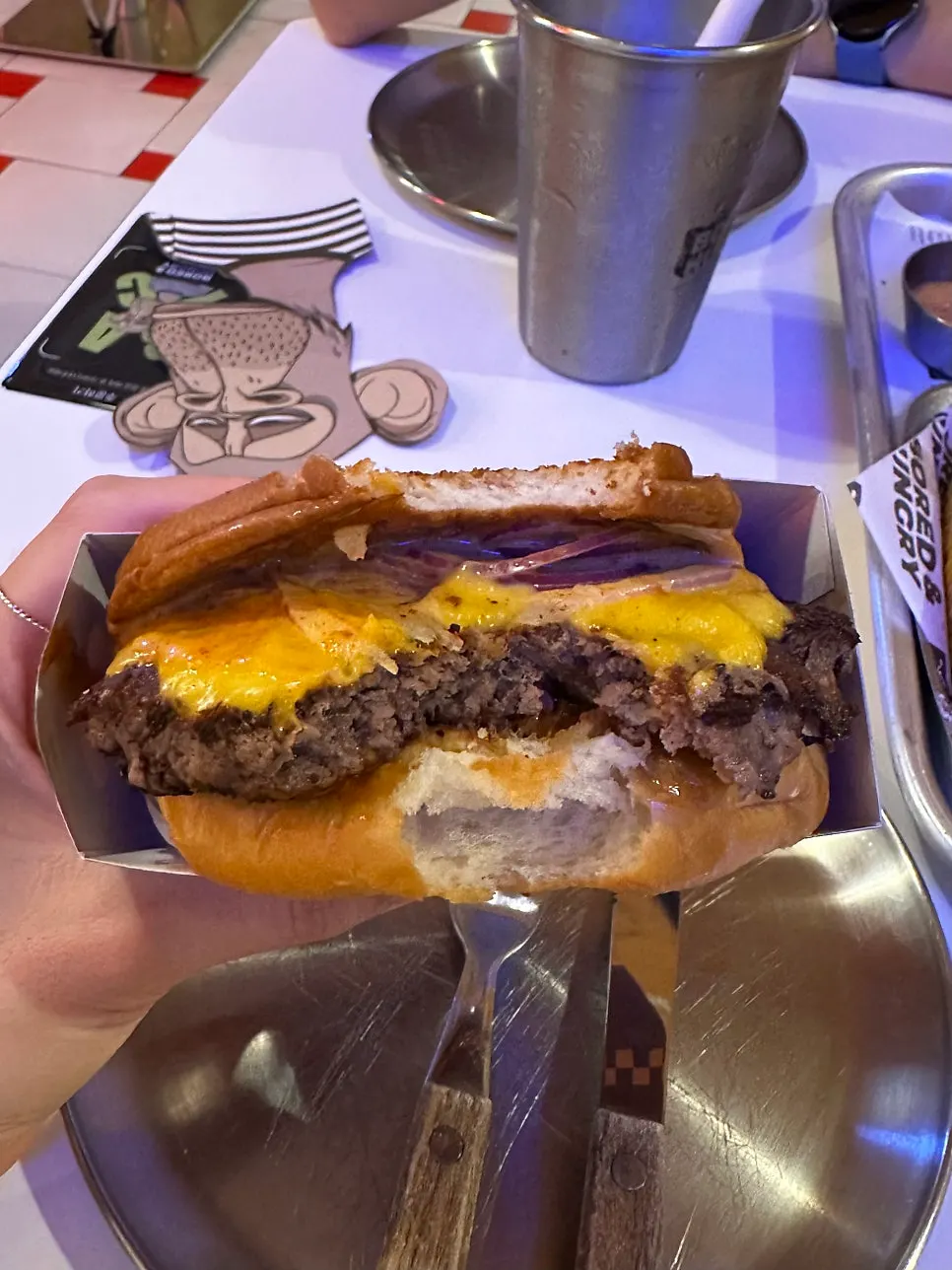 Cross-section of the Shrimp O.G. burger showing its thick shrimp patty
