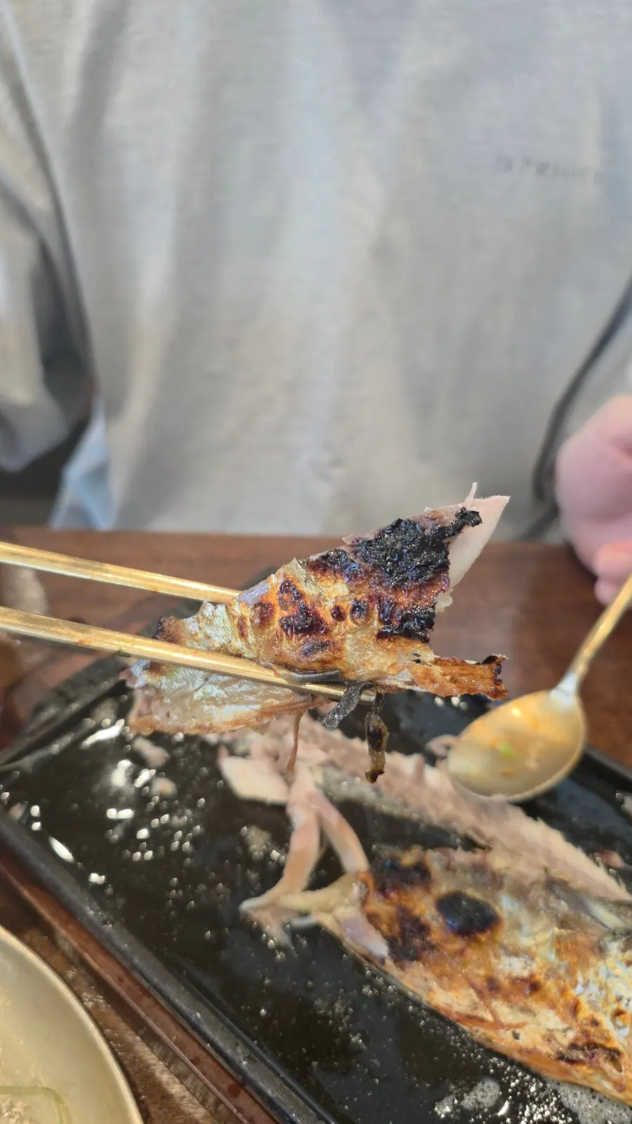 A piece of flaked-off grilled mackerel