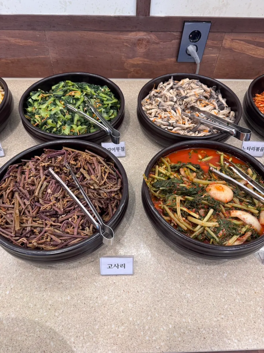 Young cabbage namul and other seasoned vegetables at the self-bar