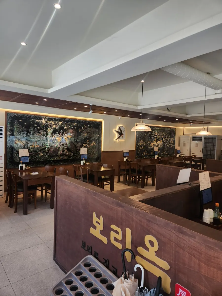 Spacious interior of Boriook Main Branch with wood-toned tables