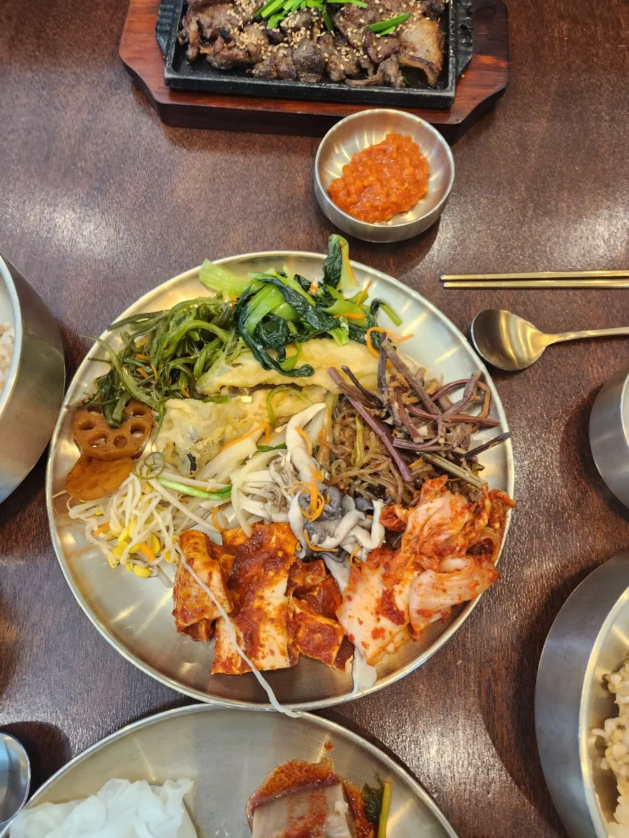 A big bowl of barley rice with side dishes