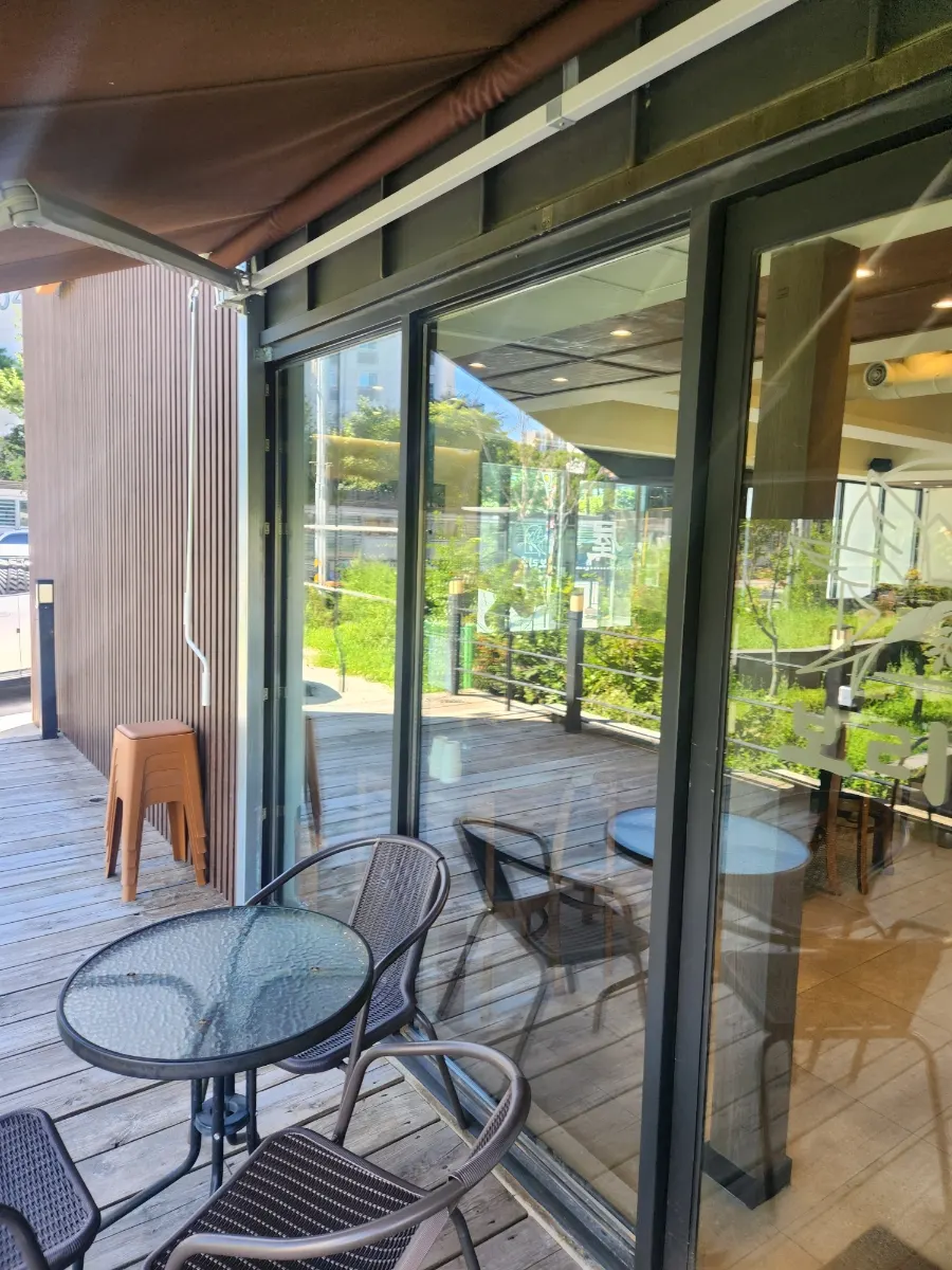 Outdoor terrace at Boriook Main Branch with round tables and chairs