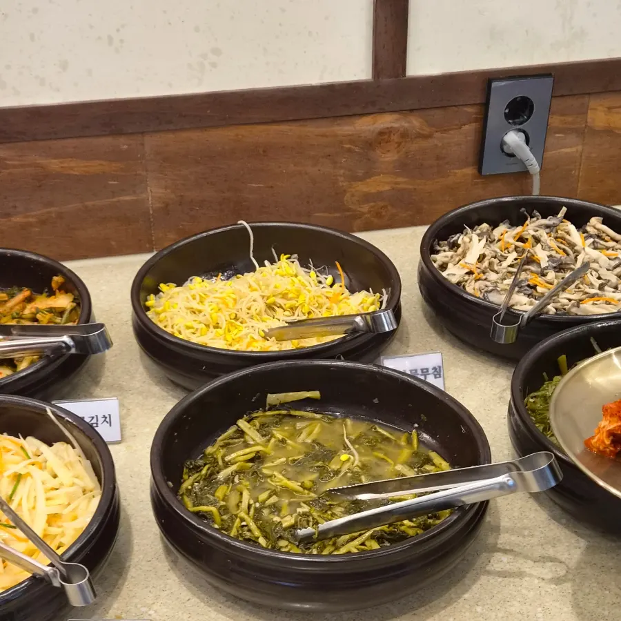 A full spread of barley rice and Korean side dishes