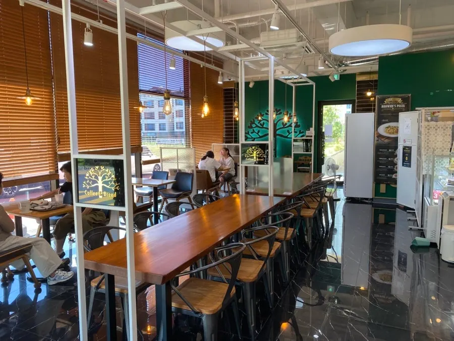 Seating and large table toward the back of the café