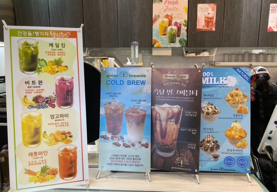 Drink menu board on the wall by the register
