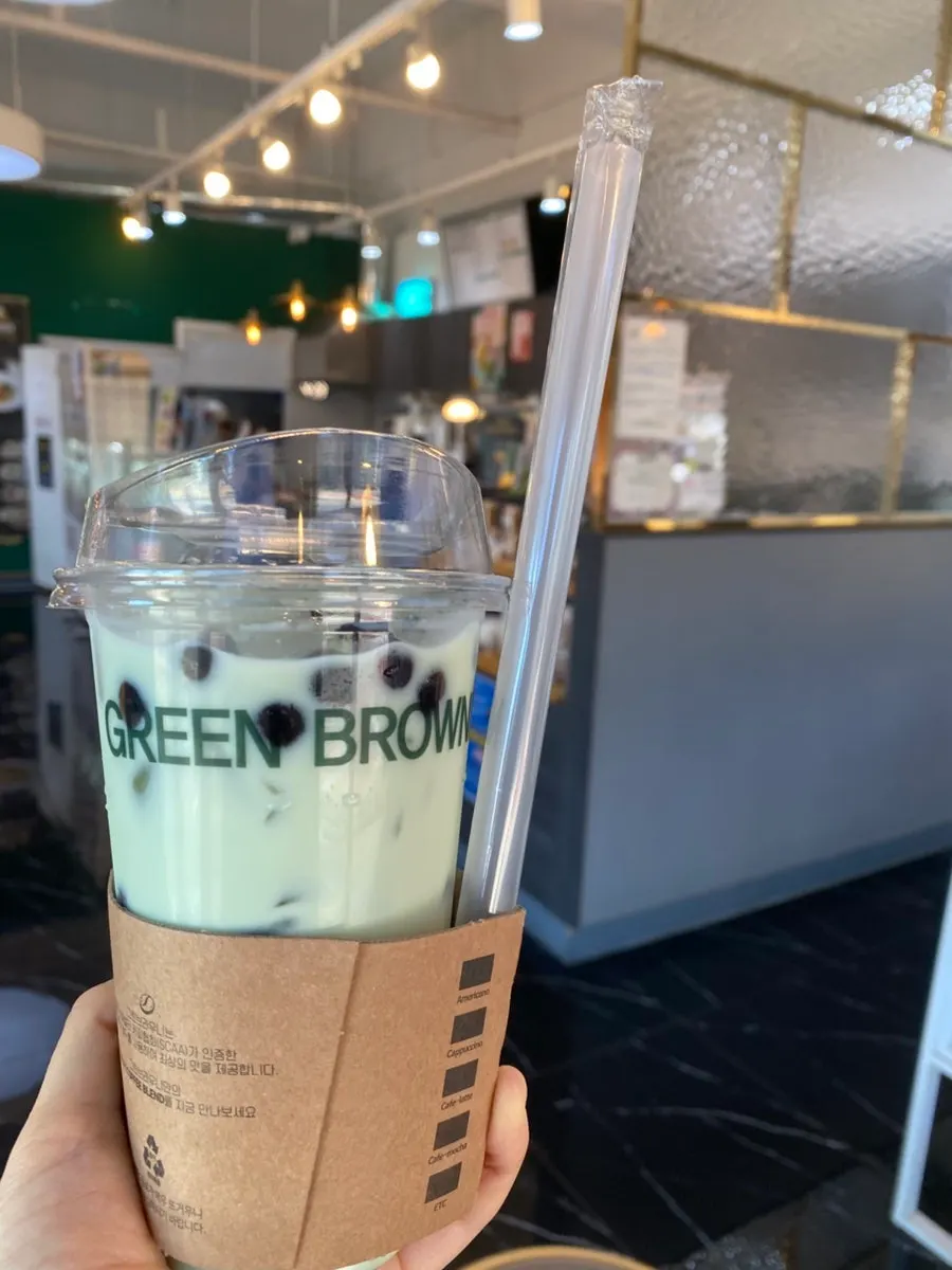 Melon bubble tea in a takeout cup