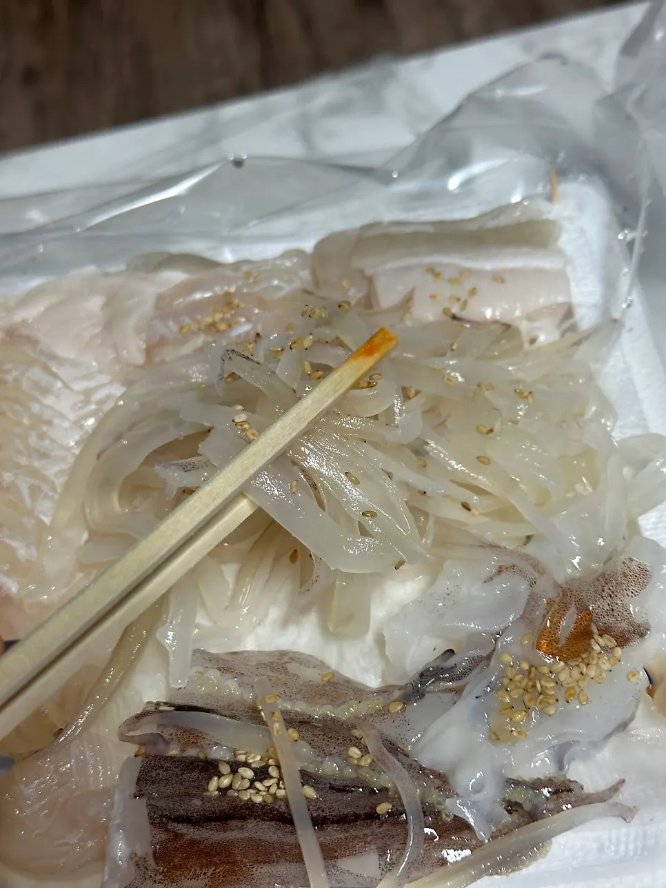 Eating the packed sashimi at the accommodation table