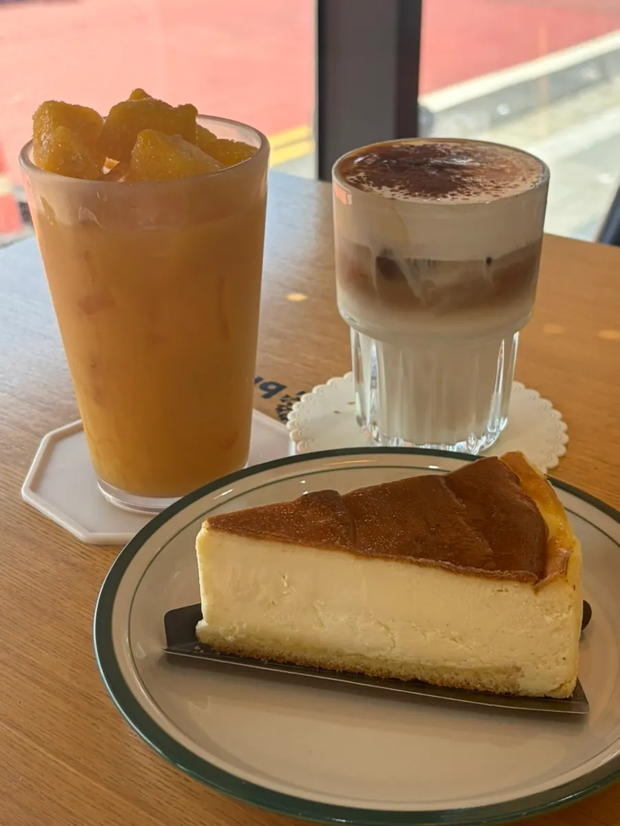 Mango-hi, signature cream latte, and Basque cheesecake set on the table