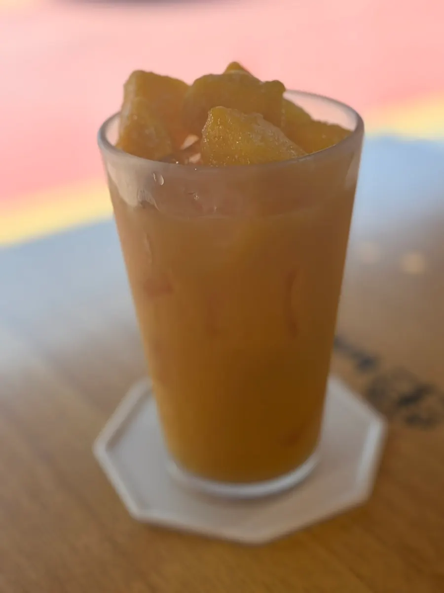 Mango-hi drink topped with mango flesh