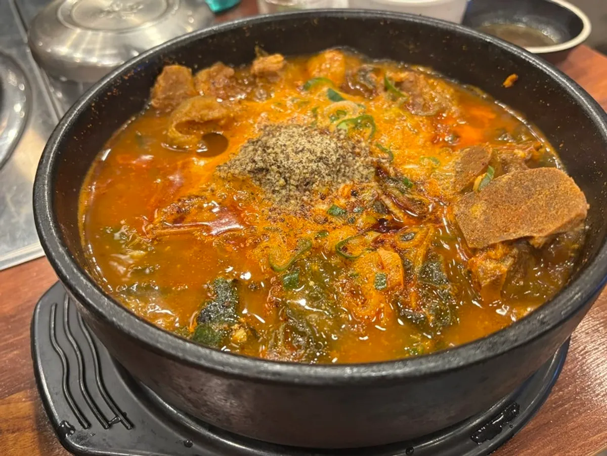 Eating the pork bone soup meat together with the broth