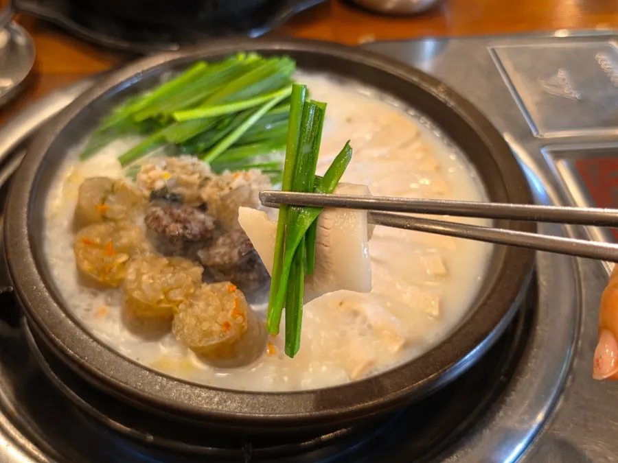 Pork jowl topped with chives, dipped in wasabi soy sauce