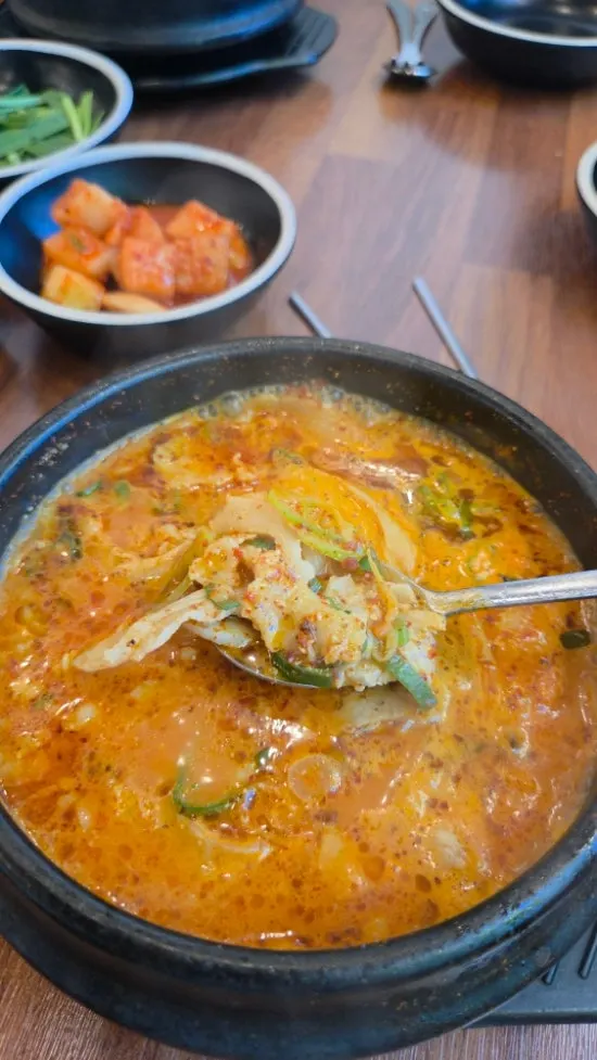 A spoonful of gukbap lifted from the bowl